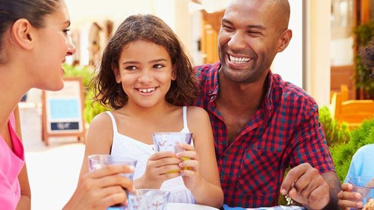 Family eating meal together at outdoor restaurant