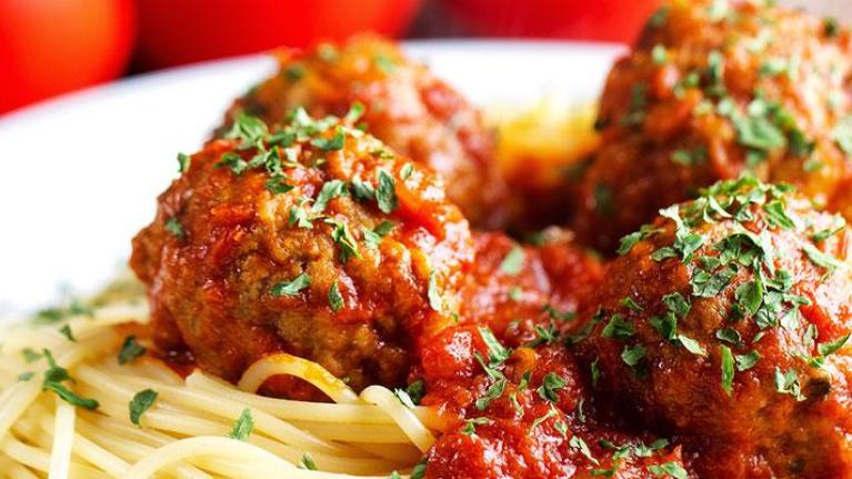 Plate of spaghetti and meatballs with garnish