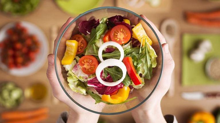 Fresh and colorful salad in glass bowl