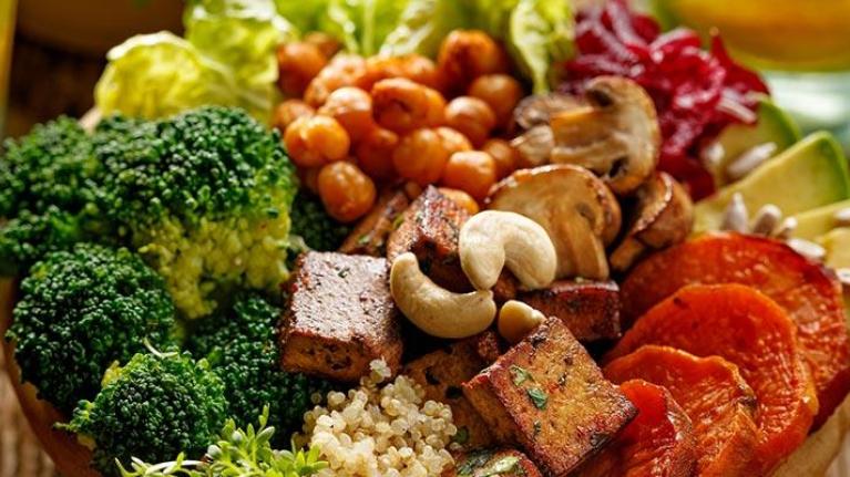 Beverages and bowl with mixed vegetables and nuts