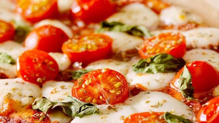 Pizza with tomatoes and basil