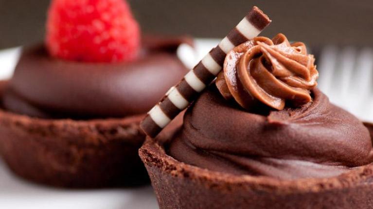 Plate of raspberry and mousse chocolate tarts