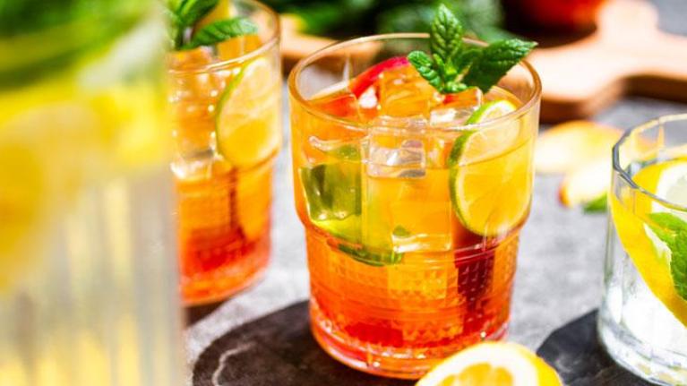 iced teas and lemonade in glasses on table