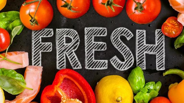 Fresh produce and meat with ‘Fresh’ written on chalkboard surface