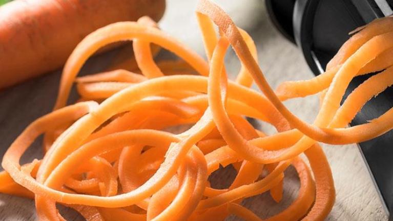 Fresh carrot sliced into spaghetti strands