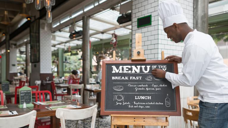 Chef changing menu sign