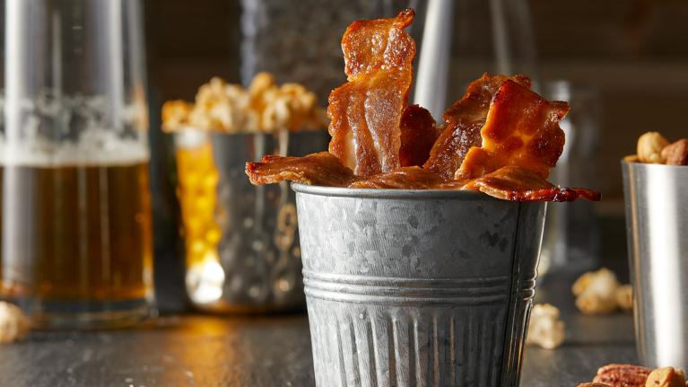 Bacon in a tin cup on a table