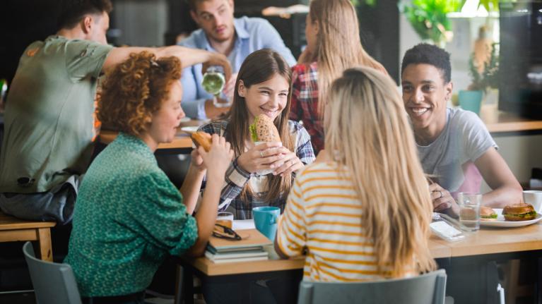 People eating sandwiches at a table