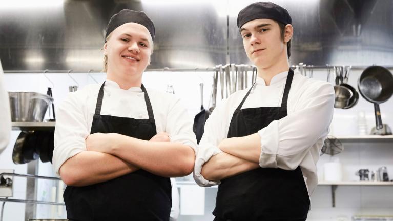 Chefs standing with arms folded