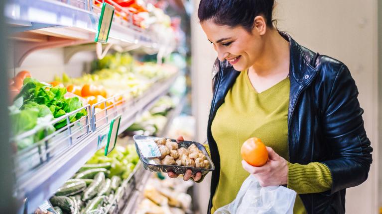 Woman at store buying produce