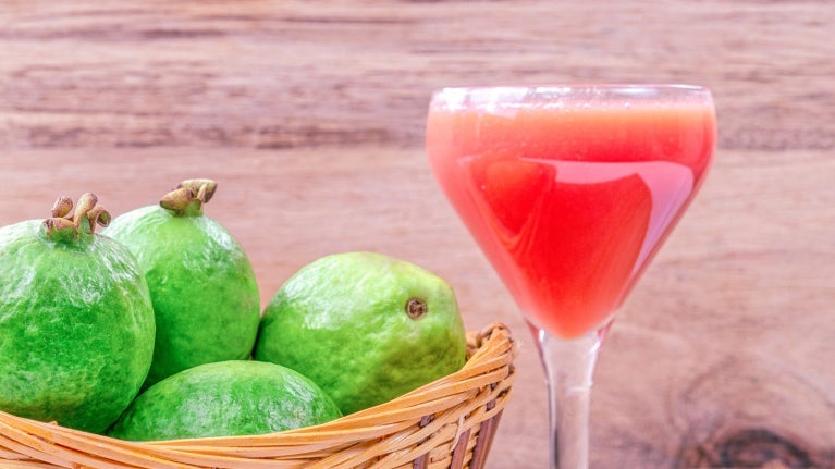 basket of pears with drink in log stemmed glass