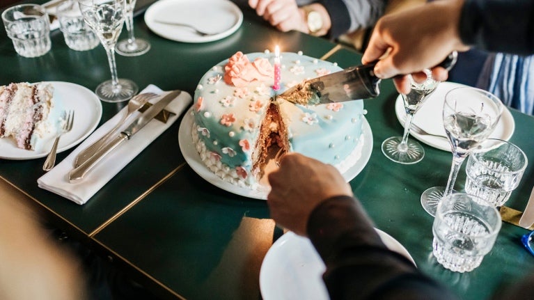birthday cake being cut on table