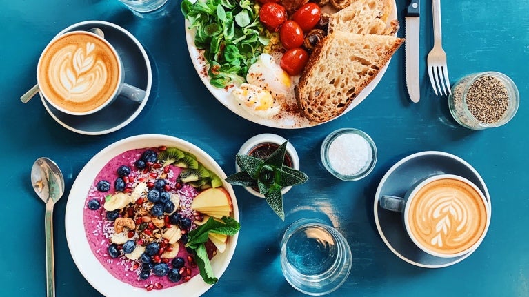 breakfast foods and a latte on table 