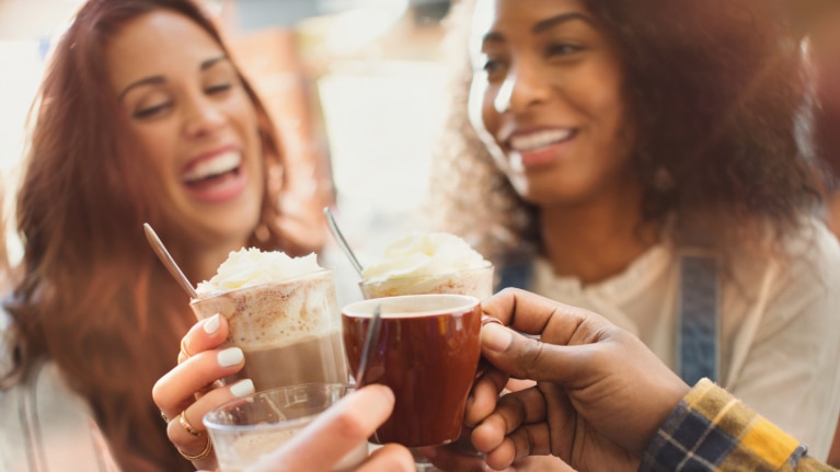 coffee culture trend report two women with coffee in hand