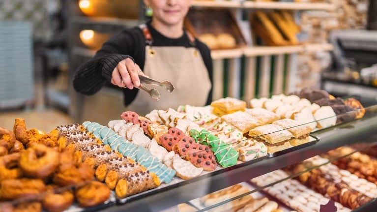 Bakery case with cannolis, cookies and donuts. 