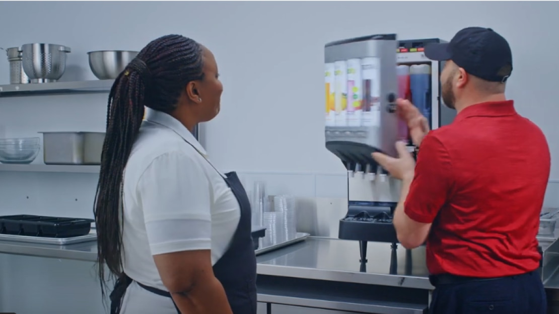 woman and man standing in front of vitality express equipment