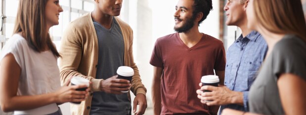 college students talking while drinking coffee