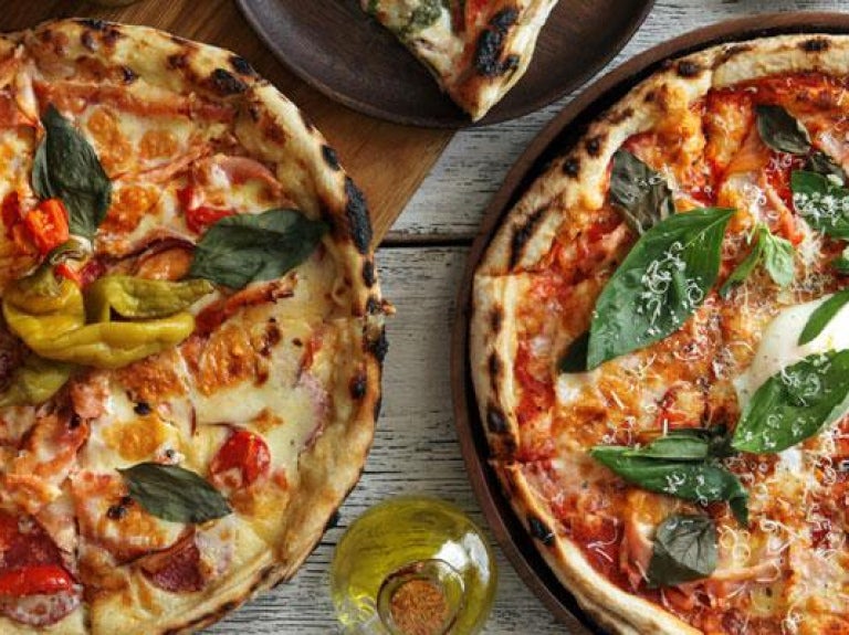 Overhead photo of two pizzas on a table