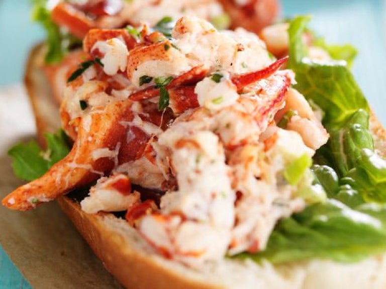Lobster roll on napkin and wood tabletop