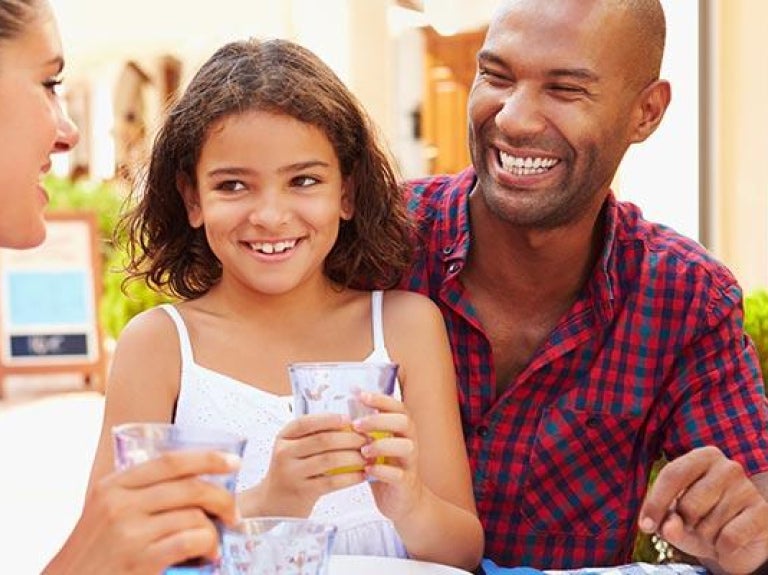 Family eating meal together at outdoor restaurant