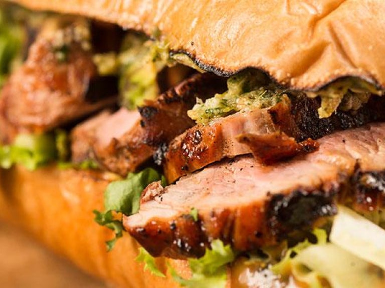 Pork sandwich on wooden platter