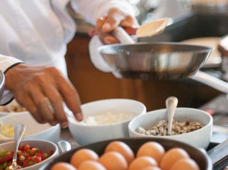 Chef preparing dish at an action station