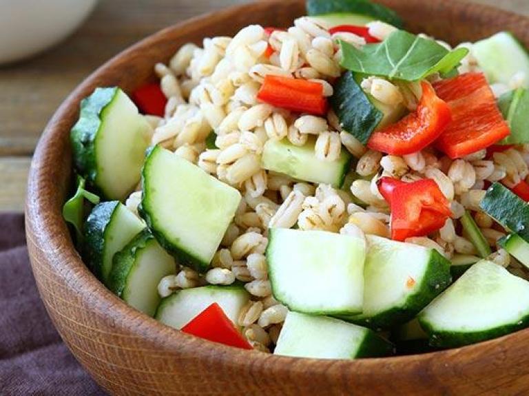 Bowl of pearl barley salad with vegetables