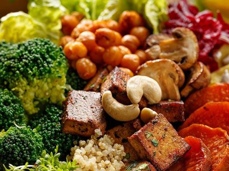 Beverages and bowl with mixed vegetables and nuts