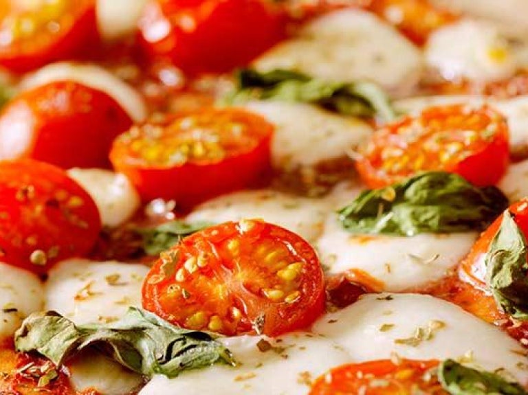 Pizza with tomatoes and basil
