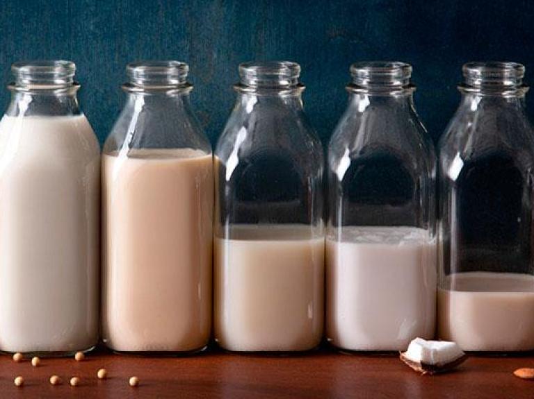 Bottles of non-dairy plant-based milk side-by-side