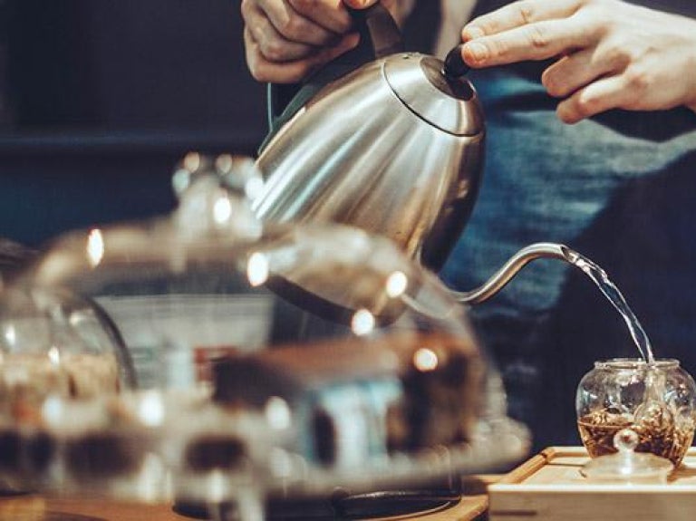 Beverage shop employee making tea