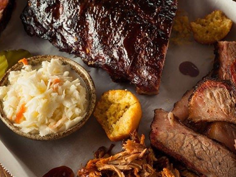 Barbecue smoked brisket and ribs platter in rustic setting