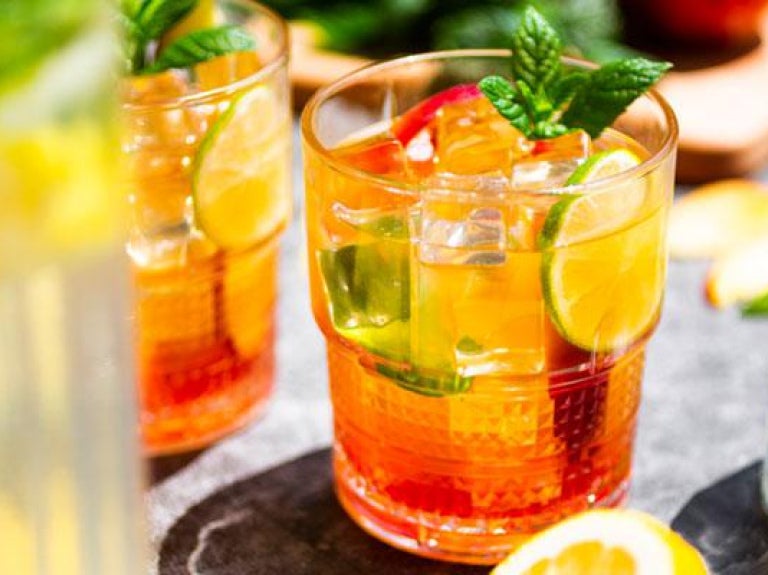 iced teas and lemonade in glasses on table