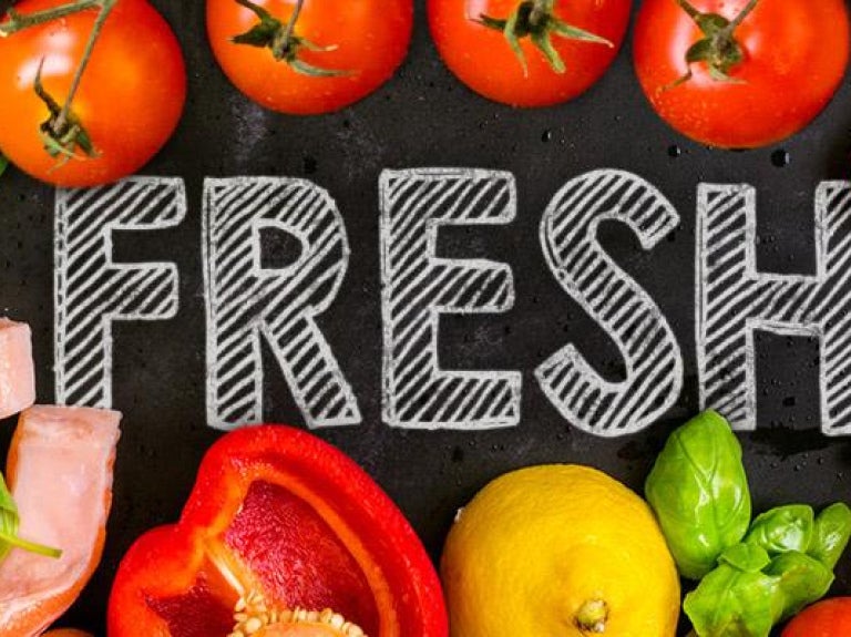 Fresh produce and meat with ‘Fresh’ written on chalkboard surface
