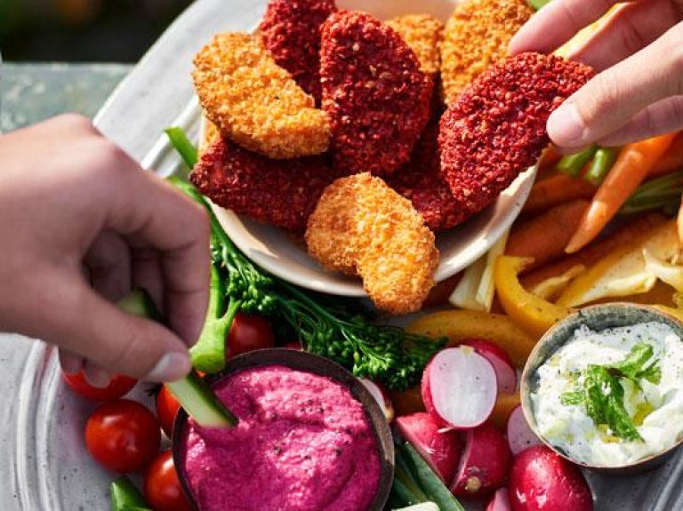 Two people sharing a healthy snack of vegetable dips