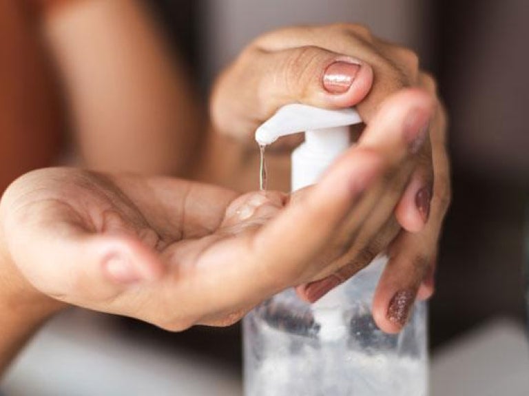 Woman pumping sanitizer into her hand