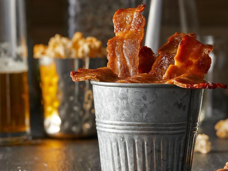 Bacon in a tin cup on a table