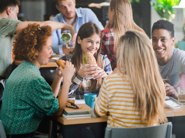 People eating sandwiches at a table