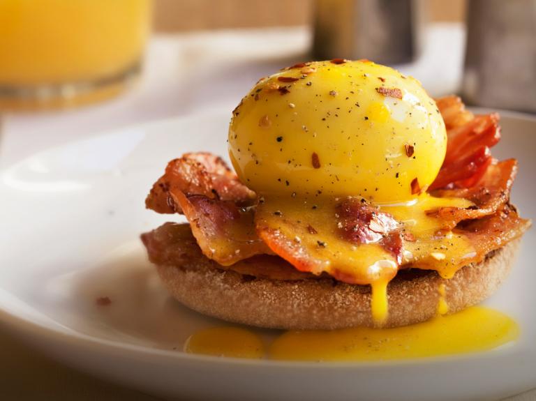 Brunch sandwich with egg and bacon and juice
