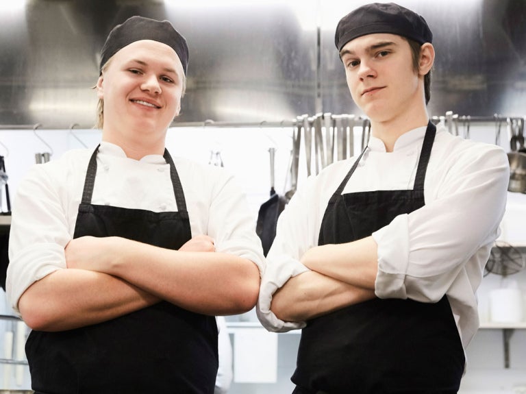 Chefs standing with arms folded