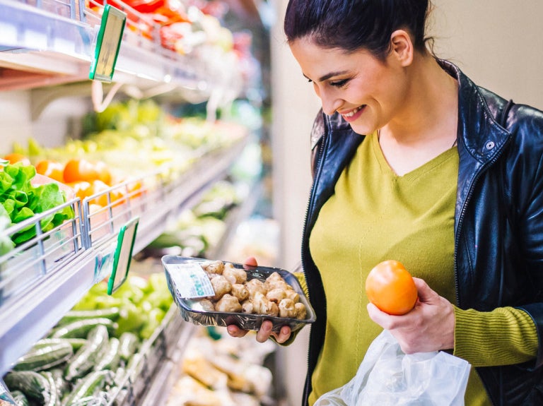 Woman at store buying produce