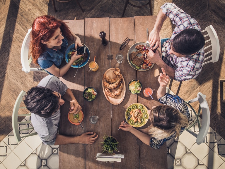 Overhead view of people at table eating