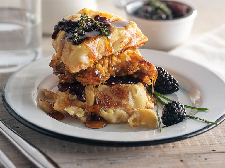 Stack of waffles and chicken with blackberries
