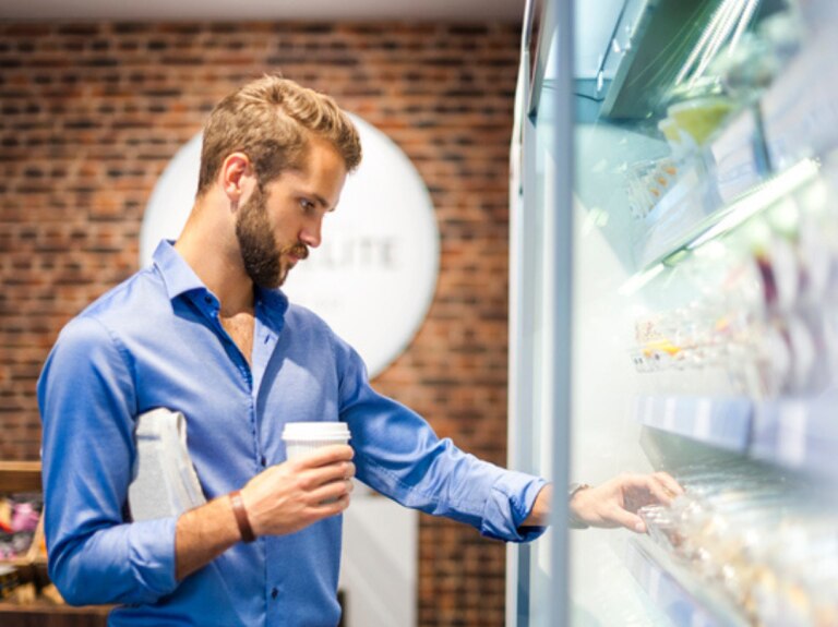 Man grabbing food from a shelf