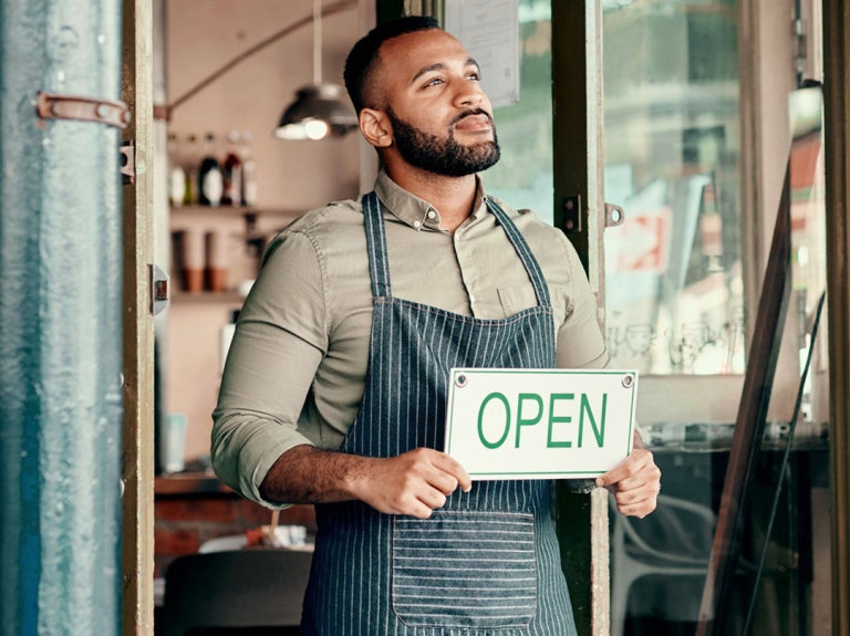 Man holding an Open sign