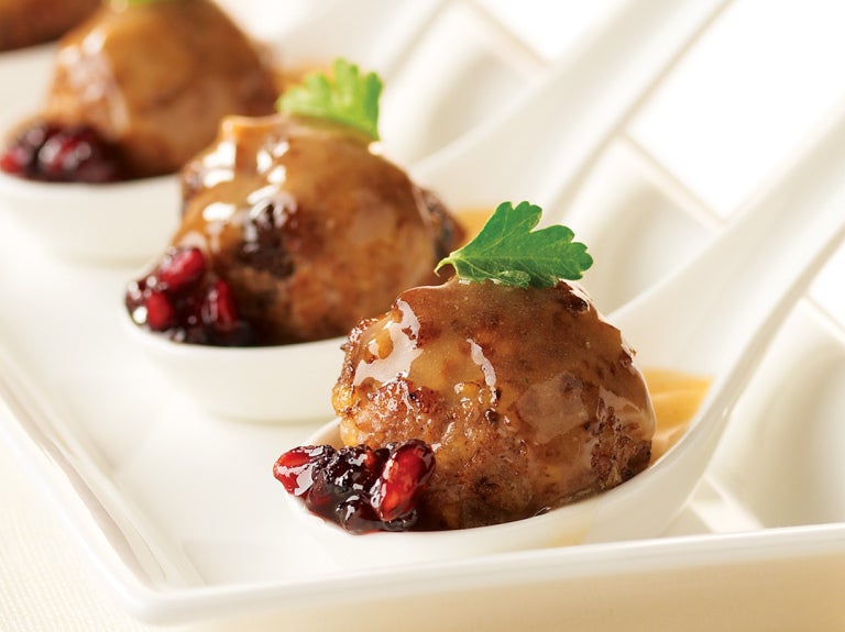 three meatballs on serving spoons