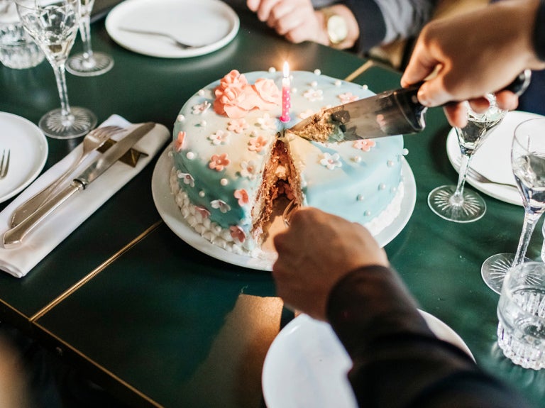 birthday cake being cut on table