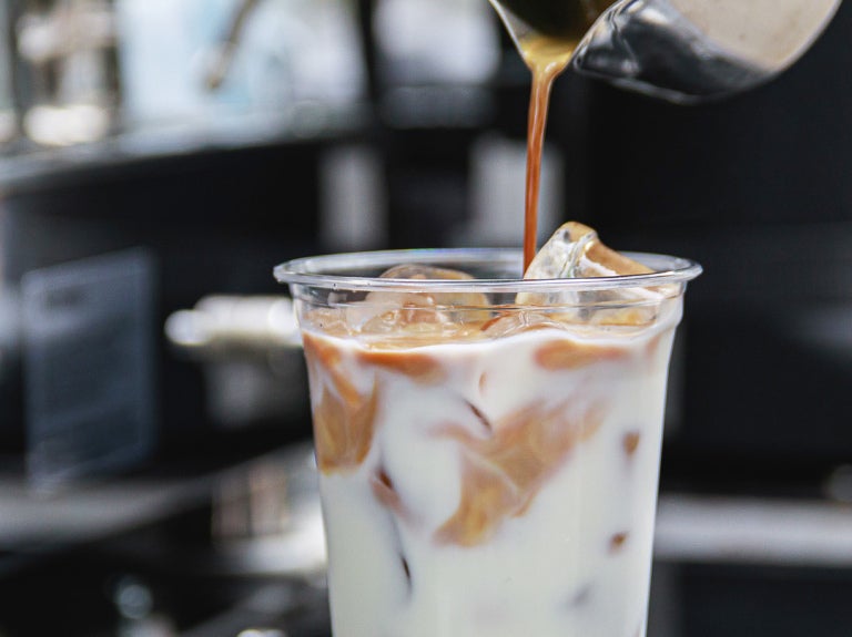 iced coffee with more coffee being poured on top