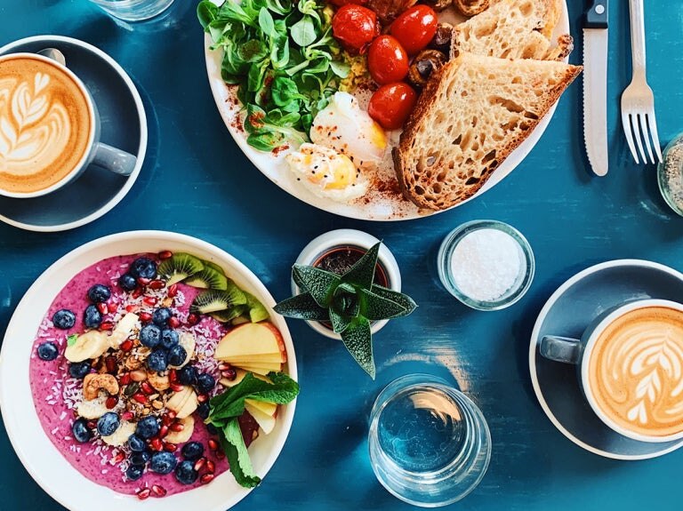 breakfast foods and a latte on table