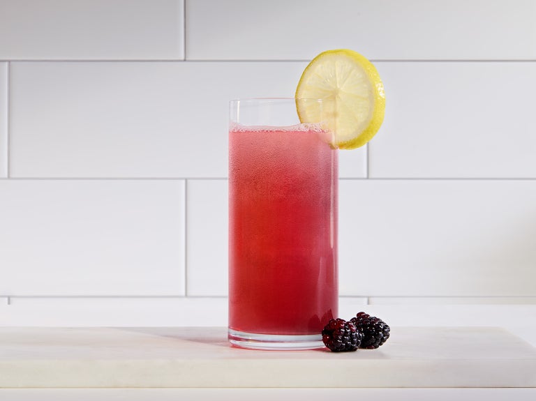 Vitality Blackberry Hibiscus in clear glass with garnish